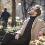 ARTAS robotic hair transplant reviews; man sitting on a park