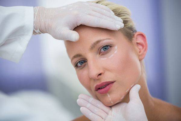 Plastic surgery; woman preparing for a facial plastic surgery