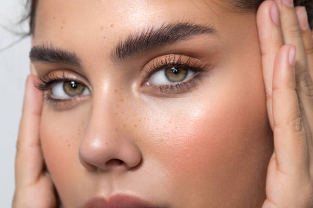 Close-up of a woman with perfectly shaped brows that reflect the ideal result after applying eyebrow design for different face shapes by a professional