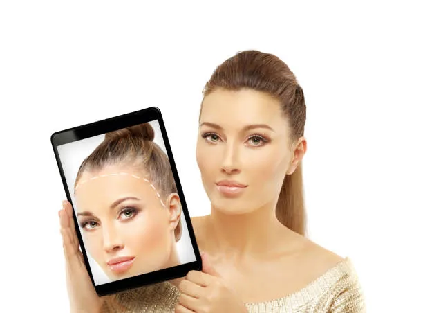 Woman holding a tablet displaying her hair before the procedure, showcasing noticeable improvement after a FUE hair transplant.