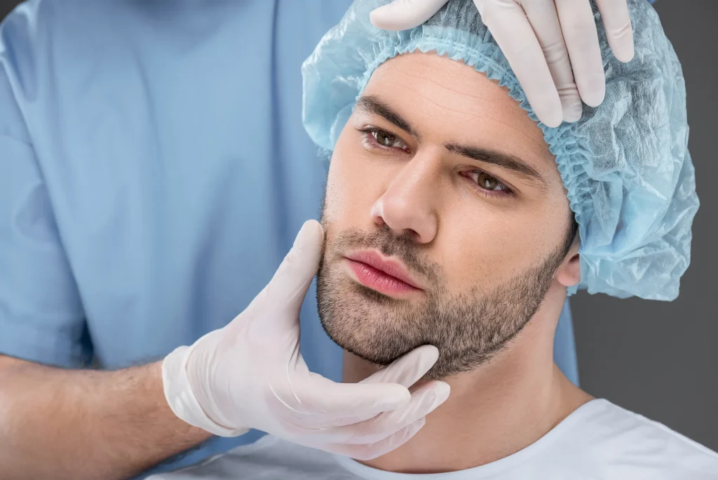 Doctor examining a male patient before facial hair restoration to estimate the beard transplant cost in Mexico.